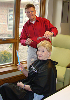 Volunteer giving a haircut