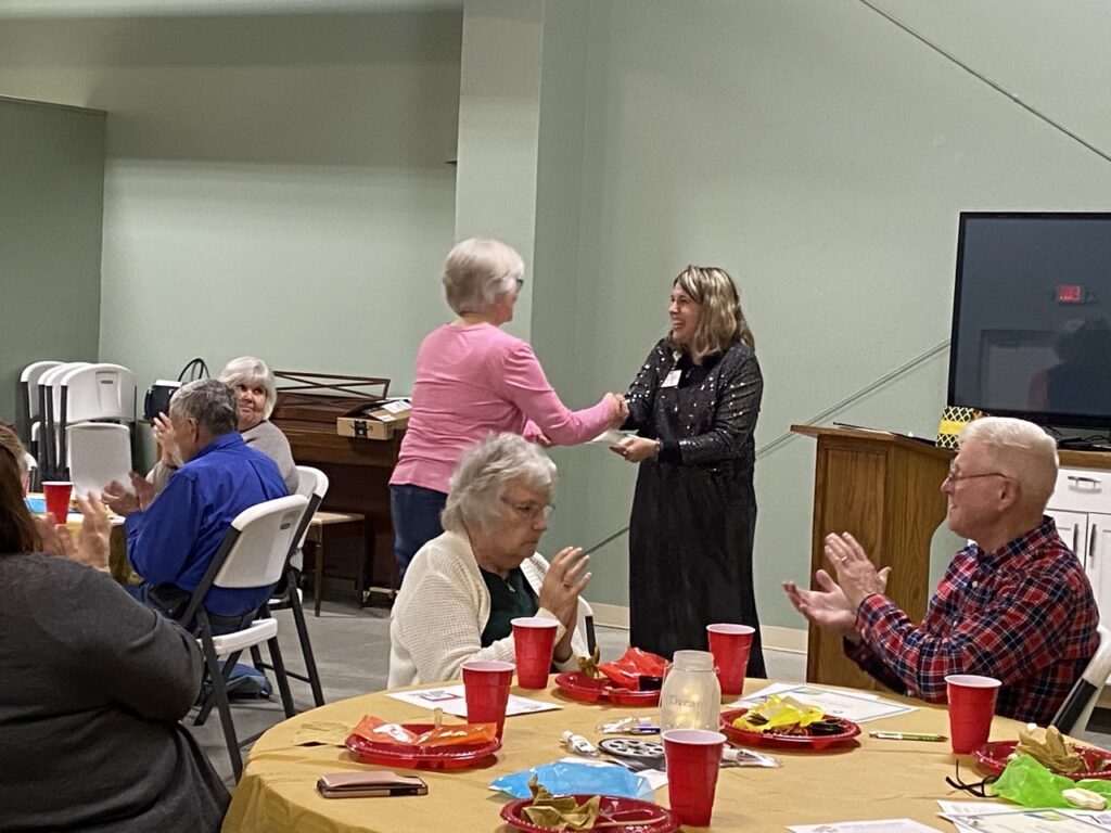 Volunteer Mary Conger receives an award.